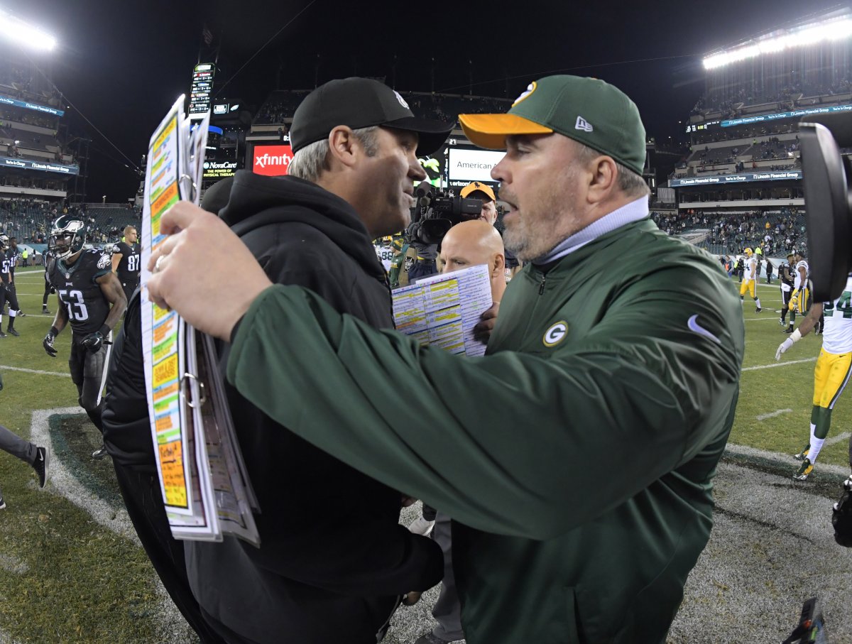 Mike McCarthy and Doug Pederson embrace after a Packers victory in 2016